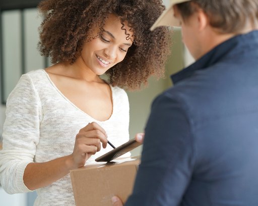 woman signing package
